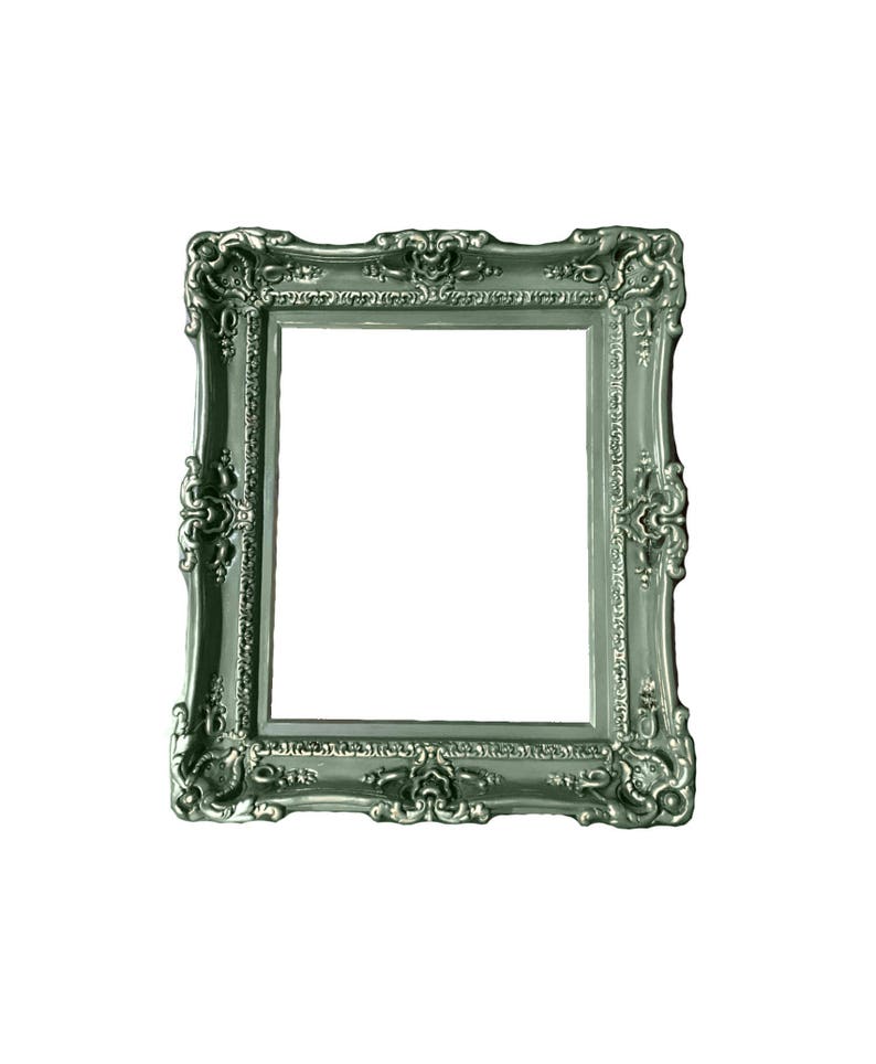 May include: A silver-colored ornate picture frame with a decorative design. The frame is empty and ready to hold a photo or artwork.
