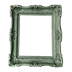 May include: A silver-colored ornate picture frame with a decorative, detailed design. The frame is made of wood and has a smooth, glossy finish.