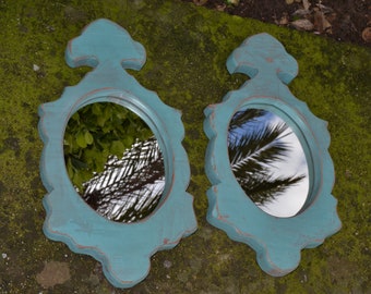 Pair of stuccoed wooden frames.