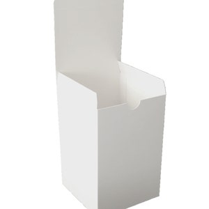 May include: A white cardboard box with a flap that opens to the top. The box is empty.