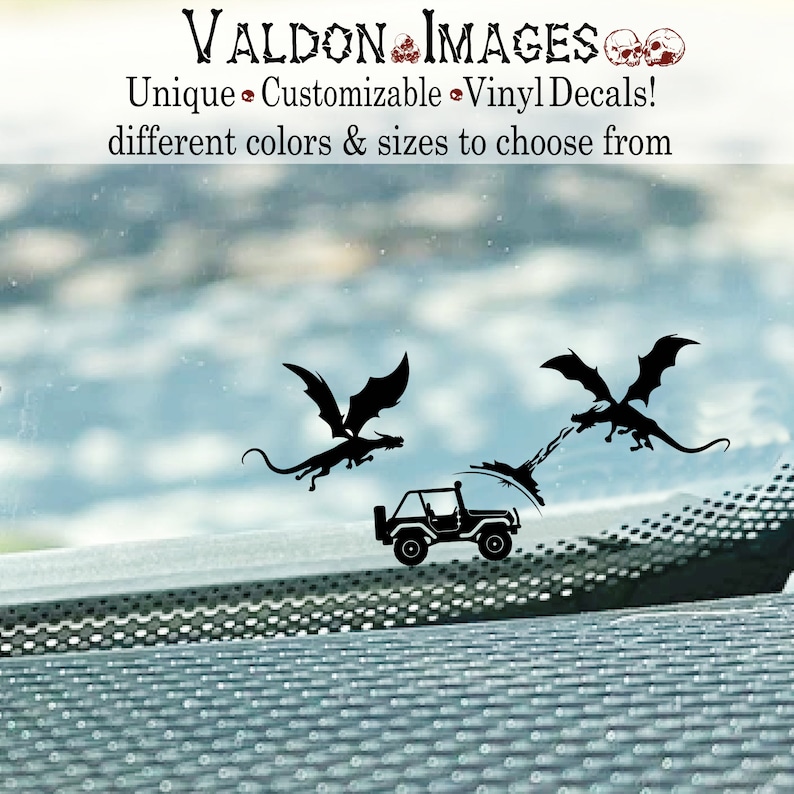 May include: Black silhouette vinyl decal of two dragons flying towards a jeep. The text "VALDON IMAGES" is at the top of the image.