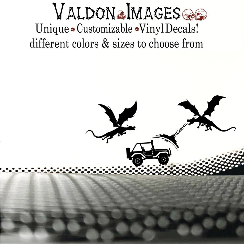 May include: Black and white silhouette of two dragons flying over a jeep. The dragons are facing opposite directions and appear to be breathing fire. The jeep is driving on a road with a dotted pattern. The text "VALDON IMAGES" and "Unique Customizable Vinyl Decals! different colors & sizes to choose from" is at the top of the image.
