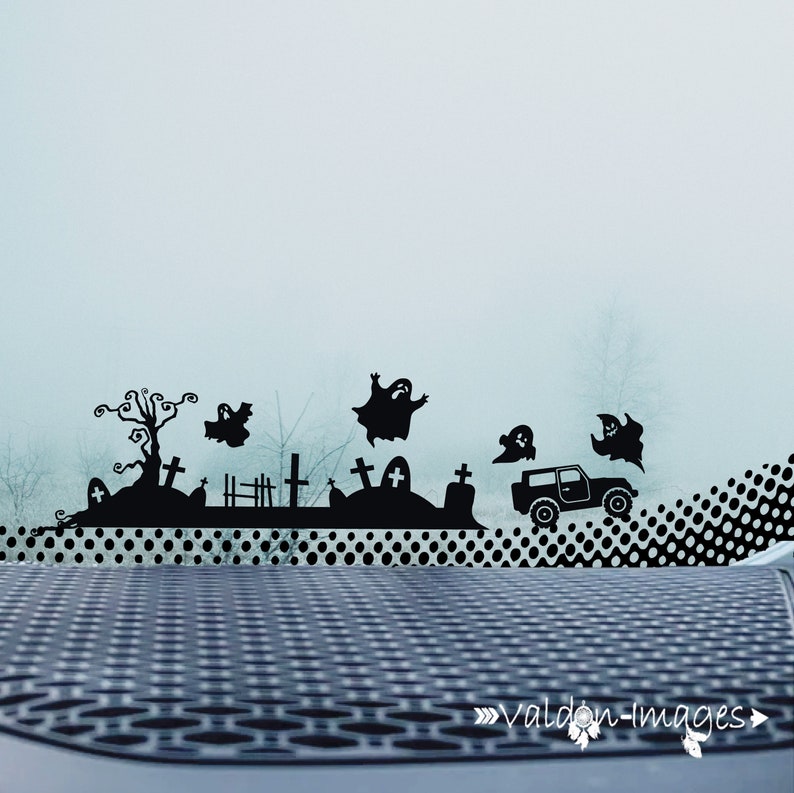 May include: A black silhouette of a graveyard with a car driving through it, ghosts flying in the air, and a dotted background. The image is a Halloween themed car decal.