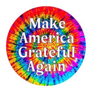May include: A round sticker with a tie-dye design in vibrant colors of red, orange, yellow, green, blue, and purple. The white text reads "Make America Grateful Again" in a bold, sans-serif font.