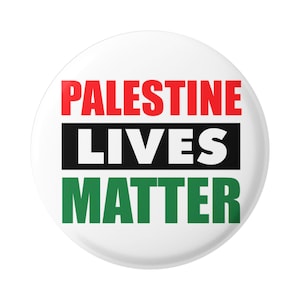 May include: A white button with the words "Palestine Lives Matter" in red, black, and green.