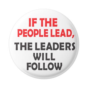 May include: White button with black text that reads "If the people lead, the leaders will follow". The word "people" is in red.