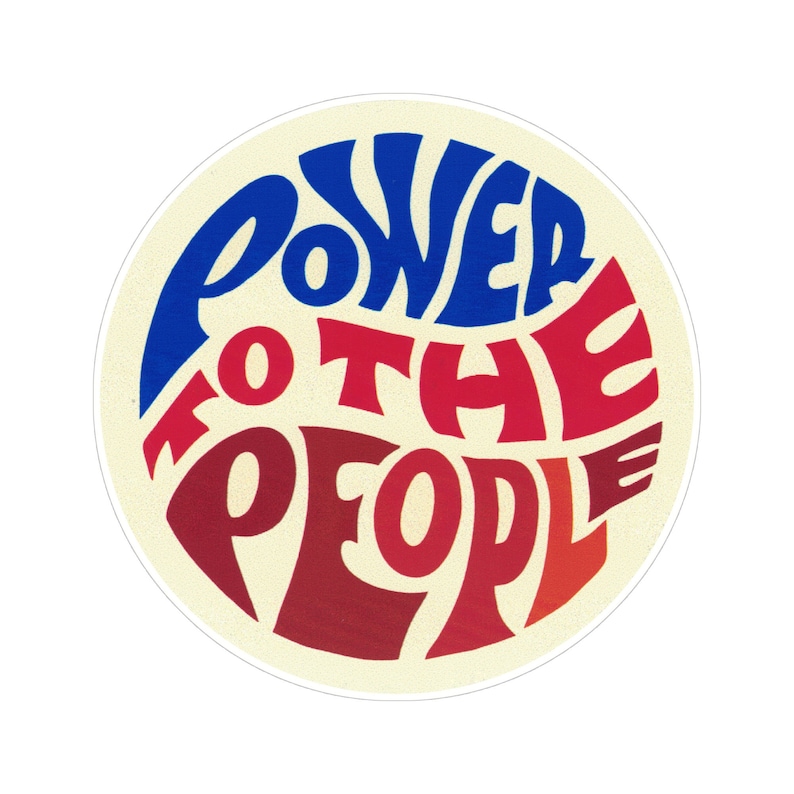 May include: A round sticker with the text "Power to the People" in a blue and red font on a cream background.