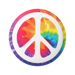 May include: A white peace sign on a colorful tie-dye background. The tie-dye pattern features shades of red, orange, yellow, green, blue, and purple.