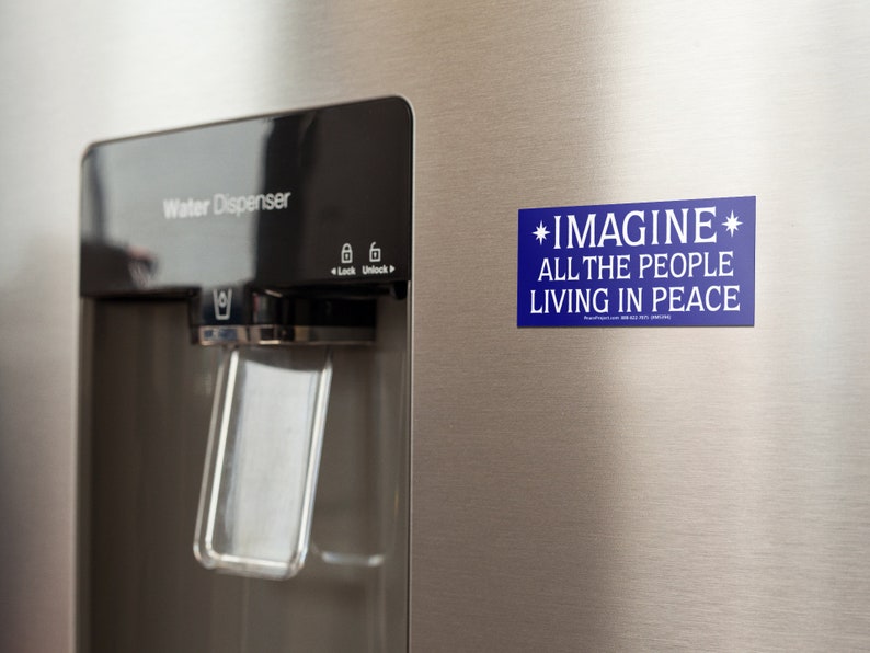 May include: A blue refrigerator magnet with white text that reads "*IMAGINE* ALL THE PEOPLE LIVING IN PEACE".