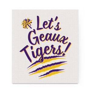 May include: Square white background with the text "Let's Geaux Tigers!" in purple and yellow. The text is in a script font with a pom-pom graphic and tiger stripe accents. The overall design is a sports-themed graphic.