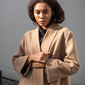 Light brown wool wrap jacket. The minimalist design is ideal for all occasions.