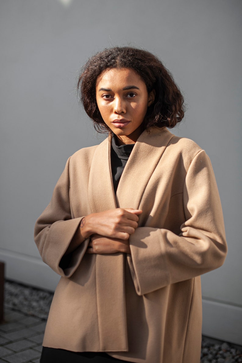 Light brown wool wrap jacket. The minimalist design is ideal for all occasions.