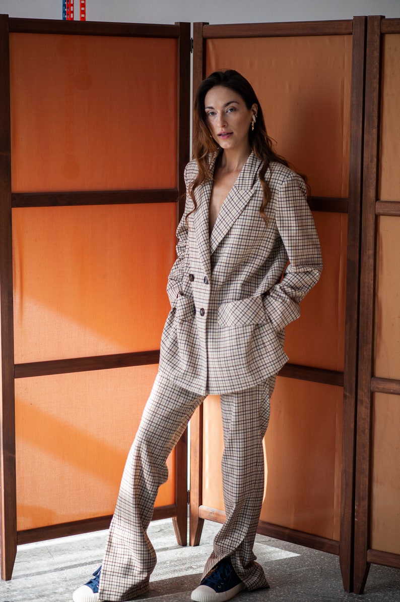 Women's wool pants in plaid fabric. Sid slits for a current look. Paired with a matching double-breasted blazer.