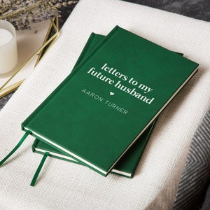 May include: A green journal with the text "letters to my future husband" and the name "AARON TURNER" on the cover.