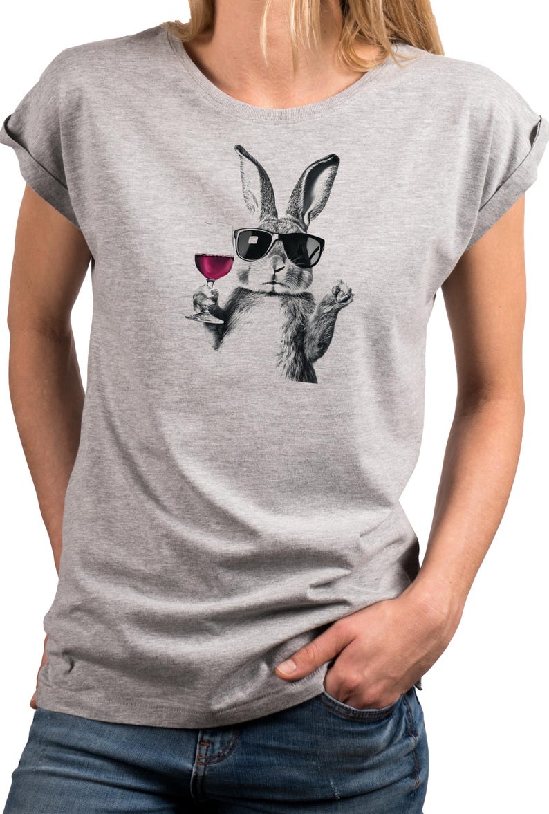 May include: A gray t-shirt featuring a black and white illustration of a rabbit wearing sunglasses and holding a glass of red wine. The rabbit graphic is centered on the shirt.