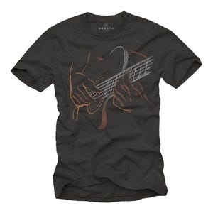 May include: Dark gray t-shirt featuring an orange and white line drawing of hands playing a guitar. The guitar strings and body are visible, with the hands positioned over the fretboard. The shirt has the brand name "MAKAYA" printed at the top.