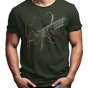 May include: Dark green t-shirt featuring a line art illustration of hands playing a guitar. The guitar strings and fretboard are visible, with the hands in a playing position. The design is in shades of orange and white.