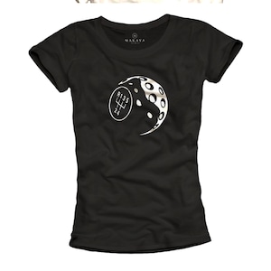 May include: Black t-shirt with a white graphic of a gear shift and a moon-like design. The gear shift pattern is visible. The shirt has a crew neck and short sleeves. The brand name "MAKAYA" is printed on the neckline.