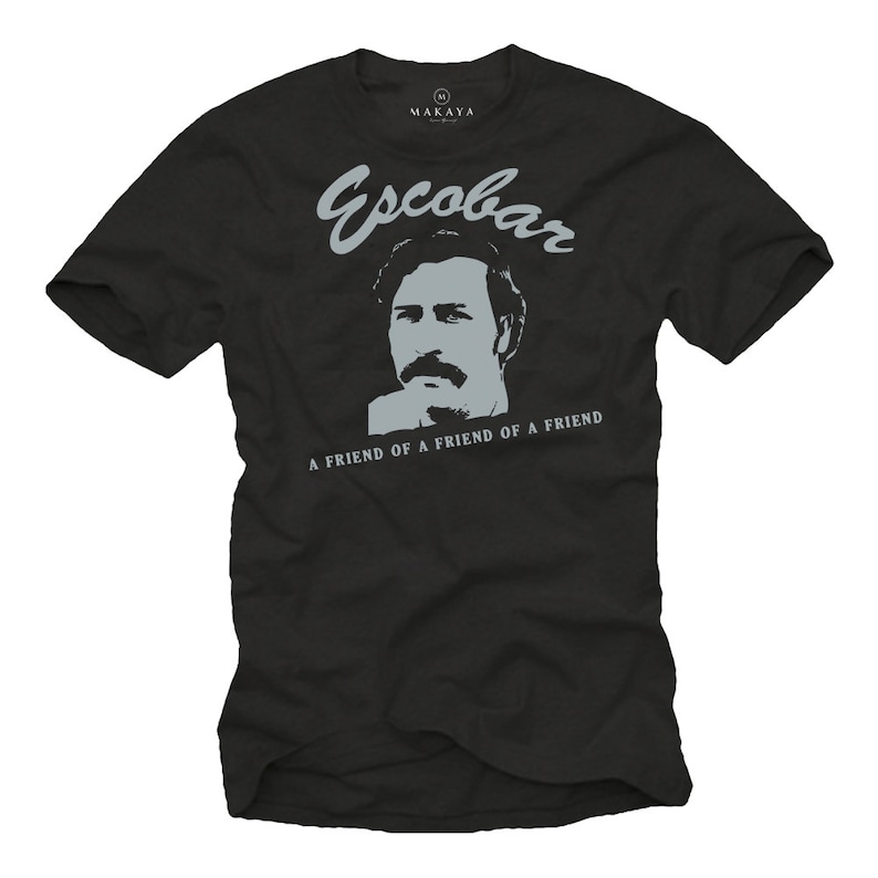 May include: Black t-shirt with a gray graphic of a man's face and the name "Escobar" above it. Below the image is the text "A FRIEND OF A FRIEND". The shirt has a crew neck and short sleeves.