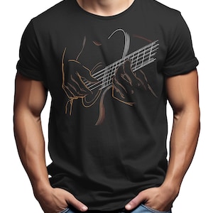 May include: Black t-shirt featuring a line art illustration of a person playing a guitar. The design uses orange and white lines to depict the guitar and the hands of the musician. The person is wearing blue jeans.
