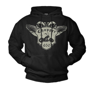 May include: Black hooded sweatshirt with a distressed graphic. The graphic features two skulls, wings, and a motorcycle with the text "Chopper LS 650". The design is in a vintage style.