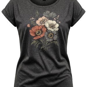 May include: Dark gray t-shirt featuring a floral design. The graphic includes a bouquet of anemone flowers in shades of red, pink, white, and gray, with green leaves. The shirt has rolled sleeves and a round neckline. The shirt is a size XS.