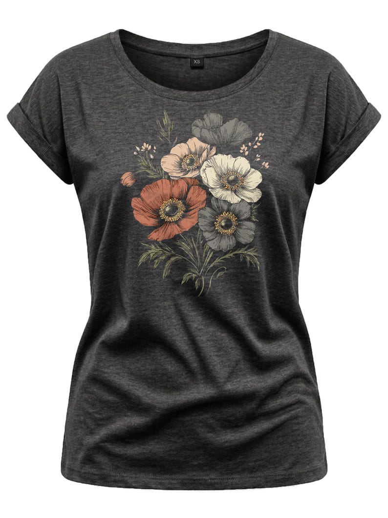 May include: Dark gray t-shirt featuring a floral design. The graphic includes a bouquet of anemone flowers in shades of red, pink, white, and gray, with green leaves. The shirt has rolled sleeves and a round neckline. The shirt is a size XS.