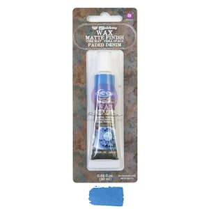 May include: A tube of Art Alchemy Faded Denim matte finish wax, 0.68 fl oz (20 ml), in a clear plastic package. The tube is blue with white text and a floral design. The package includes the text "WAX MATTE FINISH" and a swatch of the wax.