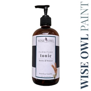 May include: A brown bottle with a pump dispenser containing Wise Owl Paint Furniture Tonic in Bourbon Vanilla scent. The label reads "Furniture Tonic, Revive & Protect, Bourbon Vanilla, 16 fl. oz. (473 ml)".