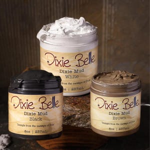 May include: Three jars of Dixie Belle Mud paint in white, black, and brown. Each jar has a label with the brand name and color. The white paint is visible on top of the jar. The jars are 8 oz | 237mL.
