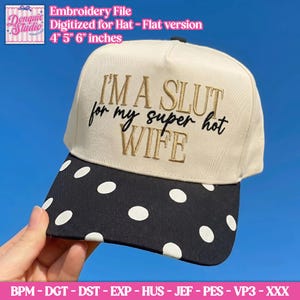May include: A cream-coloured baseball cap with a black brim featuring white polka dots. The front panel displays embroidered text in gold and black that reads I'M A SLUT for my super hot WIFE. The design is available in 4, 5, and 6 inch sizes.