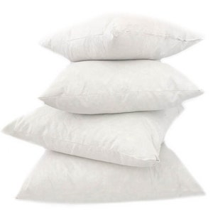 May include: Four white pillow inserts stacked on top of each other. The pillow inserts are made of a soft, fluffy material and are perfect for adding comfort and support to your favorite pillows.