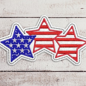 May include: Three embroidered stars in red, white and blue. The centre star has red and white stripes, while the stars on either side have blue and white stars.
