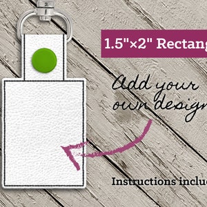 May include: White rectangular keychain with a green button and silver clasp. The keychain measures 1.5" x 2". Text on the image reads "Add your own design!" and "Instructions included".