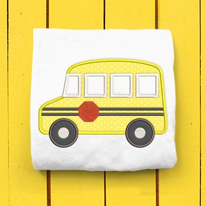 May include: A yellow school bus with black stripes and a red stop sign. The bus has white windows and a polka dot pattern.