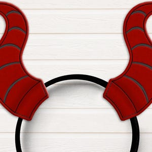 May include: Red devil horns headband with a black elastic band. The horns are made of felt and have a textured surface.