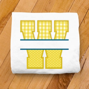 May include: A white t-shirt with a yellow and white gingham letter W split in half with a blue line. The bottom half of the letter is yellow with white polka dots.