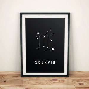 May include: Black and white print of the Scorpio constellation with the word "SCORPIO" printed below. The print is framed in a black frame.