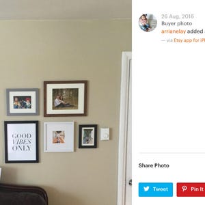 May include: A wall gallery featuring framed photos and a framed print with the text "Good Vibes Only".