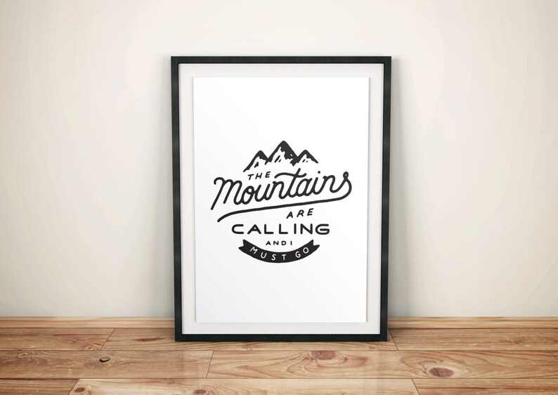 May include: Black and white framed print with a mountain range graphic and the text "The Mountains Are Calling And I Must Go."