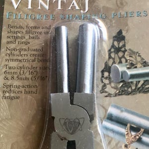 May include: A pair of silver filigree shaping pliers with two cylinders, one 3/16 inch and one 5/16 inch, in a plastic package. The package has the text "VINTAJ FILIGREE SHAPING PLIERS" and "6 & 8.5mm cylinders".