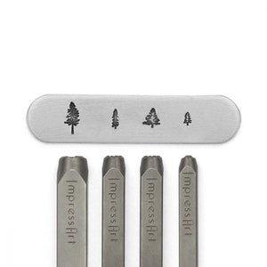May include: A set of metal stamping tools with tree designs. The set includes four stamps with different tree silhouettes and four metal stamps with the text "ImpressArt". The tools are silver-colored and are on a white background.