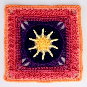 May include: A crocheted square with a colourful ombre design. The centre of the square features a yellow star with white rays, surrounded by a dark purple circle.