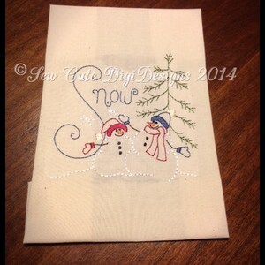 May include: Embroidered kitchen towel with two snowmen holding hands and a small evergreen tree. The text "Snow" is stitched above the snowmen. The copyright text "Sew Cute Digi Designs 2014" is in the bottom left corner.