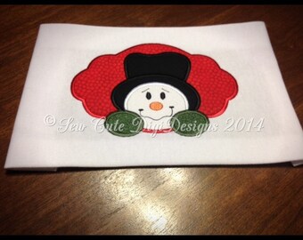 Snowman with mittens within a elegant border applique design