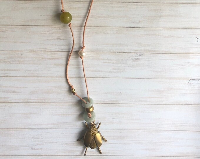 Long necklace with various types of semi-precious stones  and beetle shaped charm