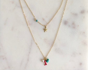 Layered necklace with turquoise howlite beads, a freshwater pearl, a starfish pendant and a coral branch enamel charm