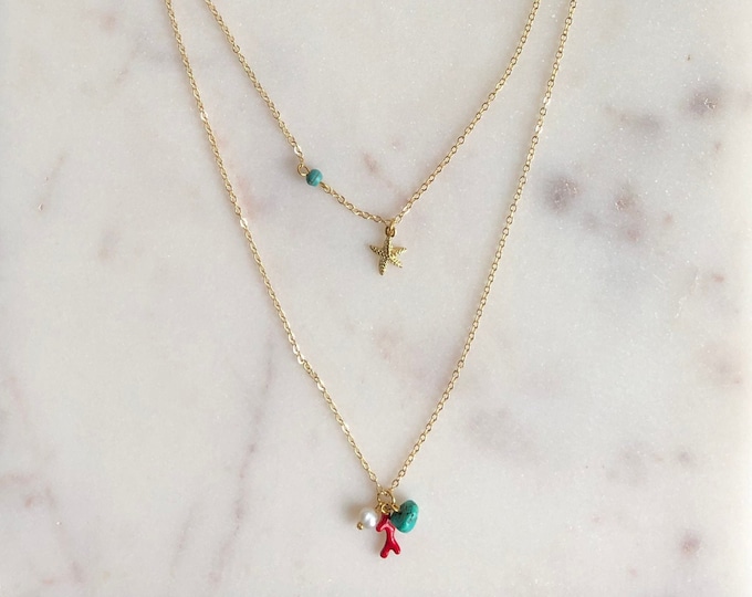 Layered necklace with turquoise howlite beads, a freshwater pearl, a starfish pendant and a coral branch enamel charm