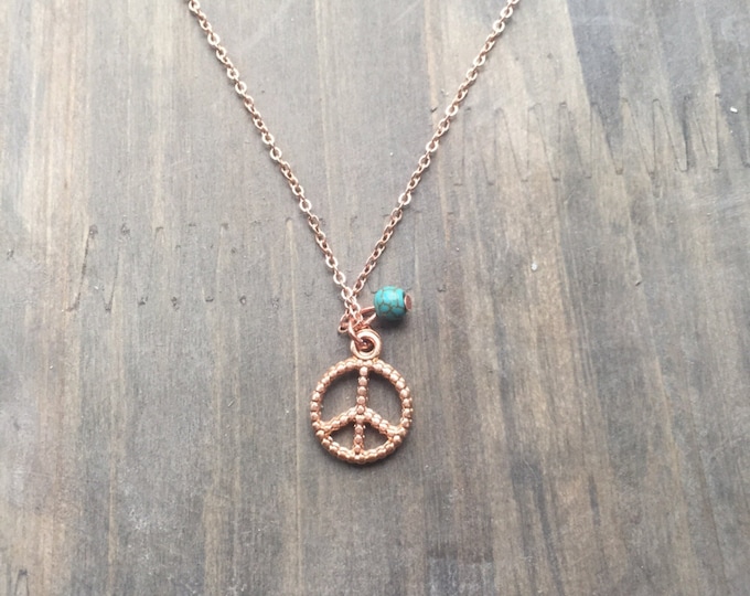 Rose gold plated necklace with peace sign and turquoise bead