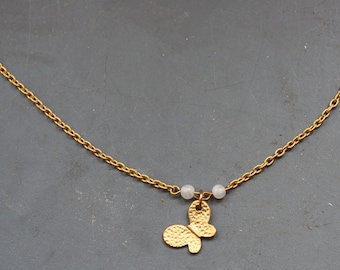 Matte goldplated necklace with white jade beads and a butterfly pendant